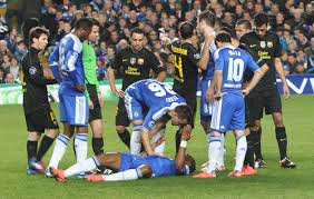 A Chelsea player goes down vs Barcelona.