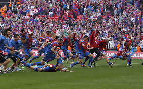 Crystal Palace players storm the field after winning promotion to the Premier League
